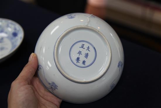 A near pair of Chinese blue and white mandarin duck and pond saucer dishes, Yongzheng mark and of the period (1723-35), diameter 15.5